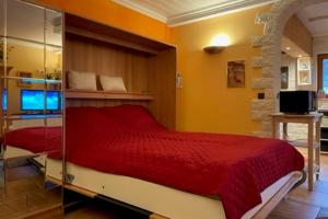 a bedroom with a red bed and a television at Ferienwohnung Le Paradis in Bad Ems