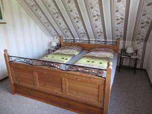 a wooden bed with two pillows on top of it at !!!NEU!!! Nordsee-Ferienwohnung Ahrendt in Westerbur