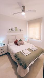 una camera da letto con un grande letto con due asciugamani di Casa Yaye Écija a Écija