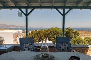 a table and chairs with a view of the ocean at Ergina Summer Resort in Antiparos