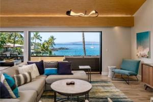 a living room with a couch and a view of the ocean at MAKENA SURF, #G-301-302 condo in Wailea