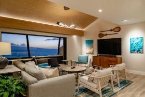 a living room with a couch and a tv at MAKENA SURF, #G-301-302 condo in Wailea