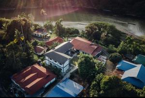 an overhead view of a house with trees and water at TEBiNG Guest House Taman Negara Malaysia Kuala Tahan in Kuala Tahan