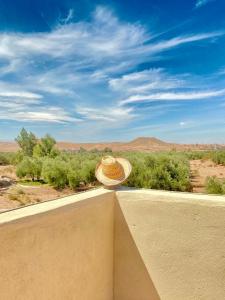 Un cappello di paglia seduto su un muro che guarda il deserto di Amazing Home in Agafay area a Marrakech
