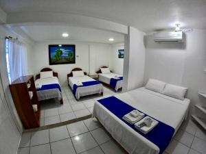 Voodi või voodid majutusasutuse Galápagos Isabela Hotel Loja toas