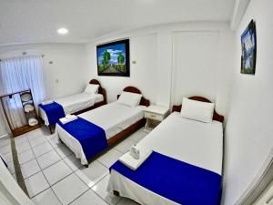 Voodi või voodid majutusasutuse Galápagos Isabela Hotel Loja toas