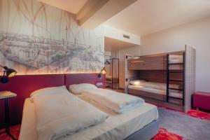 a bedroom with two beds and a painting on the wall at Campanile Berlin Brandenburg Airport in Schönefeld