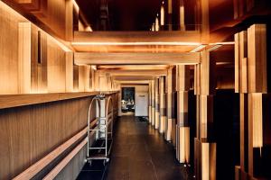 a long hallway with wooden walls and a ladder at Nobu Hotel San Sebastián in Donostia-San Sebastián