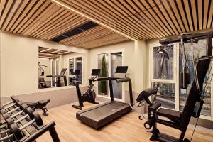 a gym with several treadmills and exercise bikes in it at Nobu Hotel San Sebastián in Donostia-San Sebastián