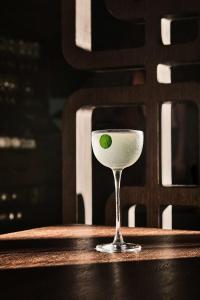 a green leaf in a martini glass on a table at Nobu Hotel San Sebastián in Donostia-San Sebastián