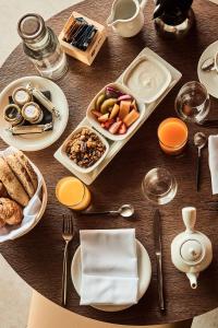 a wooden table with plates of food on it at Nobu Hotel San Sebastián in Donostia-San Sebastián