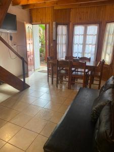 a living room with a table and chairs and a couch at El Pindo Iguazu in Puerto Iguazú