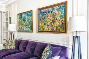 a living room with a purple couch and two paintings at Gros Caillou - Grenelle 2bdr in Paris