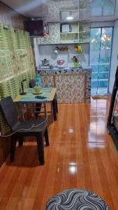 a kitchen with a table and a table and chairs at Daet Transient Tiny House staycation 2-6px in Daet