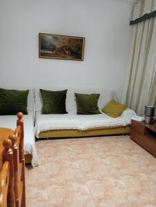 a bedroom with two beds and a painting on the wall at Habitaciónes Privadas Cartagena Murcia in Cartagena