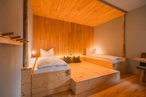 a room with two beds in a wooden room at Bergglück in Seiffen