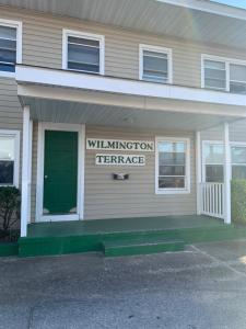 a building with a green door and a sign on it at Wilmington Terrace in Ocean City