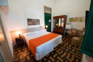 a bedroom with a large bed in a room at Pousada dos Quatro Cantos in Olinda