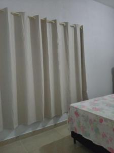 a group of curtains in a room with a table at Casa Azul in Passos