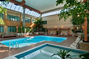 a large swimming pool in a large building at Travelodge by Wyndham Winnipeg East in Winnipeg