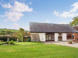 an exterior view of a house with a yard at Uk45543-the Threshing Barn in Sticklepath