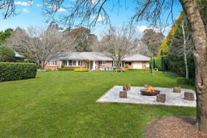 a fire pit in the middle of a yard at Avonlea, Bowral, Southern Highlands in Bowral