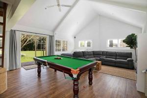 a living room with a pool table in it at Avonlea, Bowral, Southern Highlands in Bowral