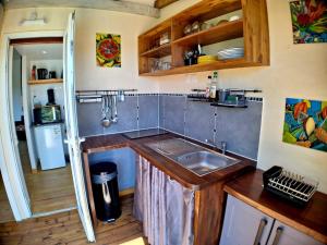 a kitchen with a sink and a counter top at L'Auxilliadora Studio - Bord de Mer et Piscine in Sainte-Anne