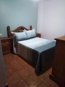 1 dormitorio con cama y tocador de madera en El Celemín, en Benalup-Casas Viejas