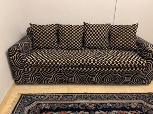 a black and white couch in a room with a rug at 3-Bedroom Apartment with Stunning Sea-Side View in Alexandria