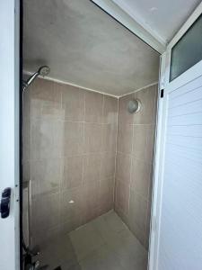 a shower with a glass door in a bathroom at Dar mi Yamna in Rabat