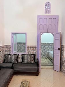 ein Wohnzimmer mit einem Sofa und einem Spiegel in der Unterkunft Dar mi Yamna in Rabat