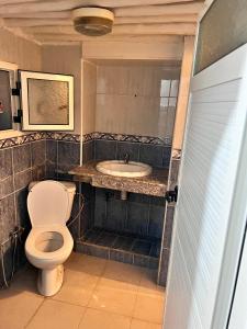 a bathroom with a toilet and a sink at Dar mi Yamna in Rabat