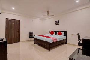 a bedroom with a bed with red pillows on it at Super OYO Flagship 81926 Hotel MN Stays in Vijayawāda