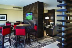 a restaurant with red chairs and tables in a room at AeroStay in Sioux Falls