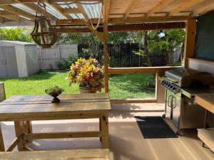 a patio with a wooden table and a stove at Hushed Miramar Town in Miramar
