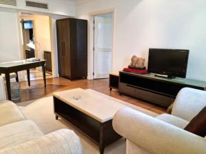 a living room with a couch and a tv and a table at The Jerai Hotel Alor Star in Alor Setar