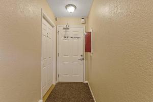 a hallway with a white door with a sign on it at Tranquil 2BR Apt Mpls - 8073 Apt 1 in Spring Lake Park