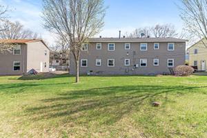 a large house with a grass yard in front of it at Tranquil 2BR Apt Mpls - 8073 Apt 1 in Spring Lake Park