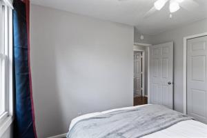a bedroom with a bed and a ceiling fan at Tranquil 2BR Apt Mpls - 8073 Apt 1 in Spring Lake Park