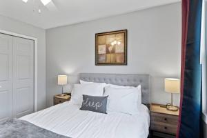 a bedroom with a bed with white sheets and pillows at Tranquil 2BR Apt Mpls - 8073 Apt 1 in Spring Lake Park