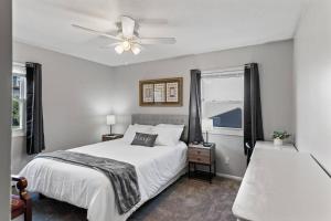 a bedroom with a bed and a ceiling fan at Tranquil 2BR Apt Mpls - 8073 Apt 1 in Spring Lake Park