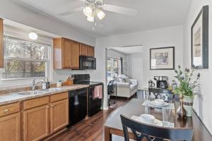 a kitchen with a black appliances and a table at Tranquil 2BR Apt Mpls - 8073 Apt 1 in Spring Lake Park +20 photos