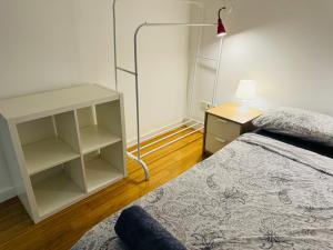 a bedroom with a bed and a lamp and a shelf at El capricho de Nina en Lavapiés in Madrid