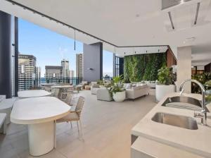 a large room with tables and chairs on a building at Above Broadbeach casino 1BRplus Study ocean-city views in Gold Coast