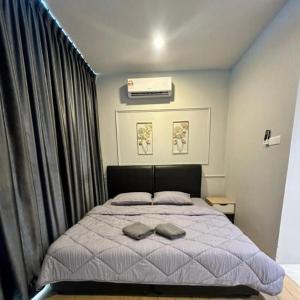 a bedroom with a bed with two towels on it at Manhattan Suites by NAJ in Penampang