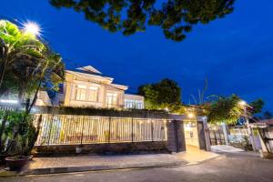 a house with a fence in front of it at night at 1/9 Hồ Quý Ly, bãi sau in Vung Tau