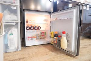 an open refrigerator filled with food and drinks at 恐竜博物館まで車で5分 自然体験 古来農業体験ができる一棟貸し宿Dinosaur Agri in Katsuyama