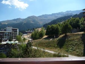 a view of a city with mountains in the background at 2 Pièces, skis aux pieds, proche commerces avec balcon. Capacité 6 pers, animaux non admis - FR-1-771-11 in Les Adrets