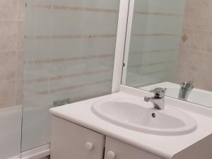 a bathroom with a white sink and a mirror at Appartement Les Adrets-Prapoutel, 2 pièces, 4 personnes - FR-1-771-31 in Les Adrets